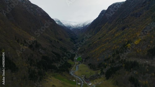 aerial view over river in canyon between moutnains with Buerbreen glacier on background in norway photo