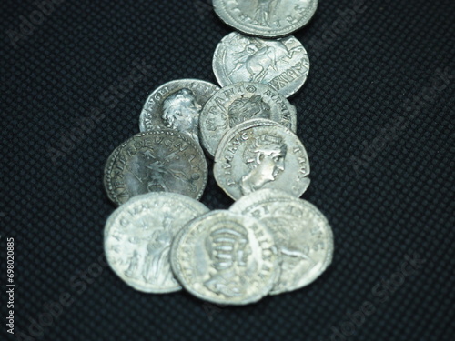 Roman gold and silver coins on a black background photo