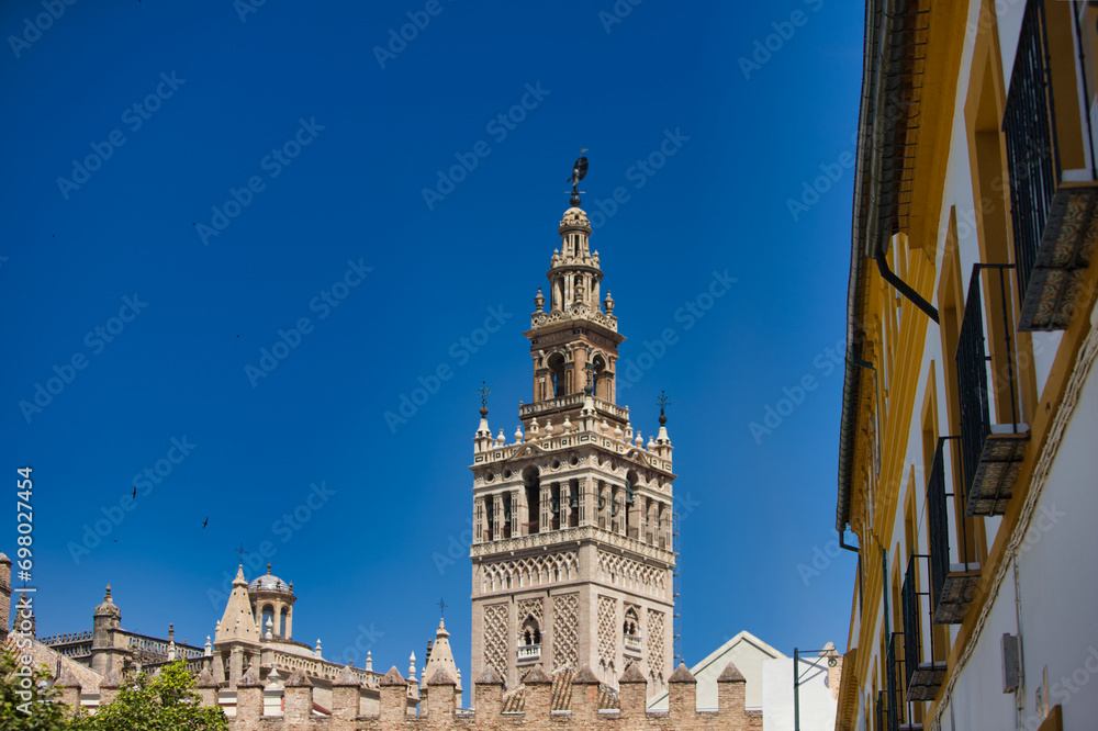 Seville Cathedral Giralda Tower from the door of the Alcazar arch Seville Andalusia Spain.