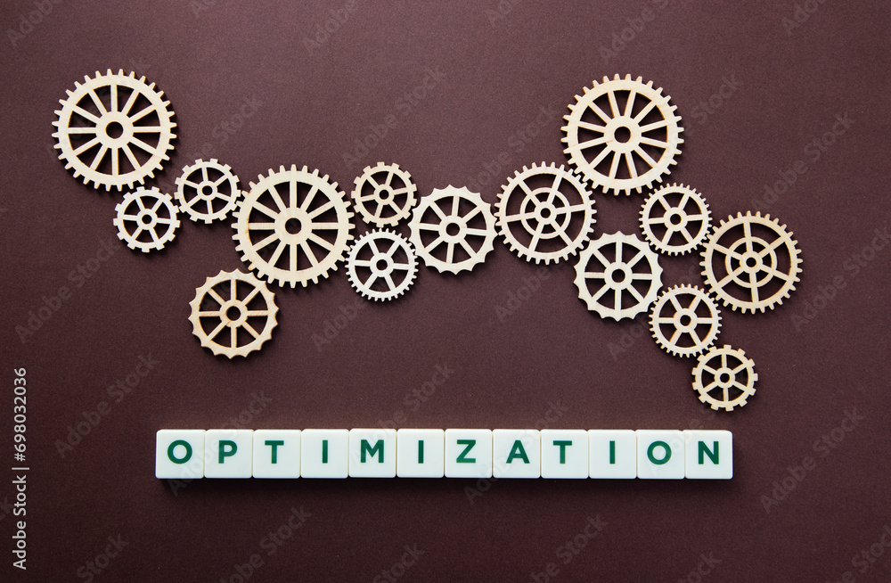 Wooden gear with the word Optimization. Technology concept and optimization. Wooden gear with the word Optimization. Technology concept and optimization.