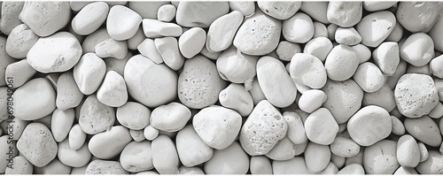 Collection of various rocks and pebbles. Smooth white stones with intricate patterns create abstract and soothing composition. Light and shadow enhances texture and depth to arrangement photo