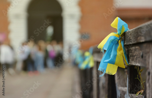 Ribbons in the colors of the national flag of Ukraine are tied to the handrail. Yellow-blue tapes