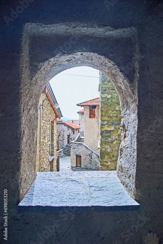 The stone housing througn the window, Bre, Ticino, Switzerland photo