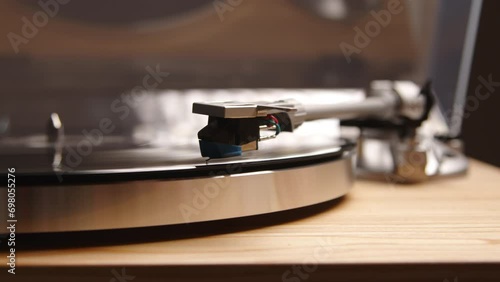Close up of a vinyl player as the needle drops onto the record and classical music begins to play. A vintage homage to the fashion of the past century. High quality 4k footage