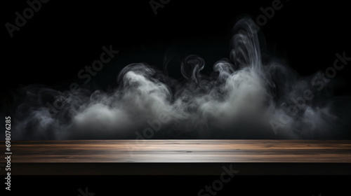 Empty wooden table with smoke float up on dark background