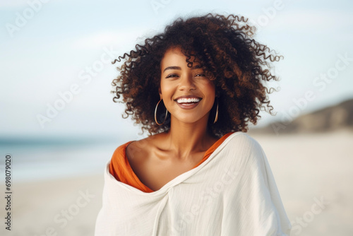 Portrait of a cute black woman on a summer walk on the beach