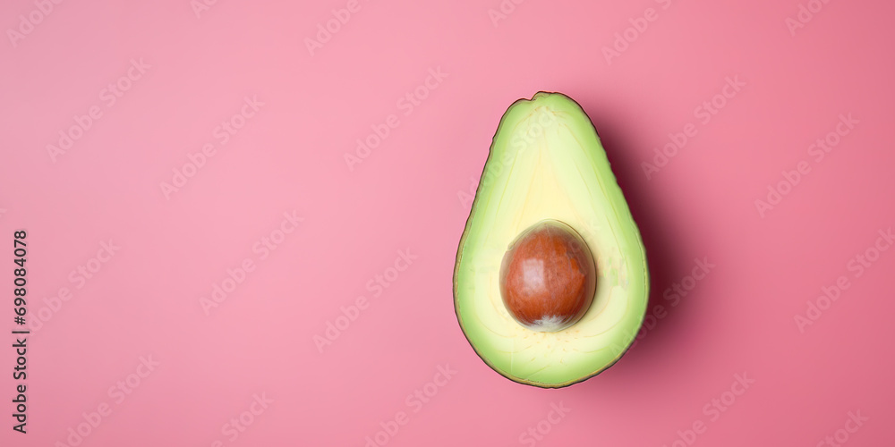 A avocado against pink background ,healthy food, Fiber , Folic acid