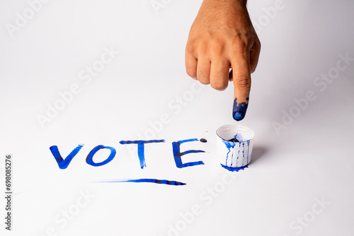 photo of blue finger in Election ink bottle 
