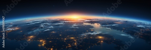 A panoramic view of Earth from space is decorated with glowing city lights