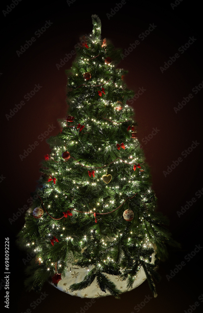 Christmas tree with decorations and garlands with lights on a dark background Christmas tree with decorations and garlands with lights on a dark background