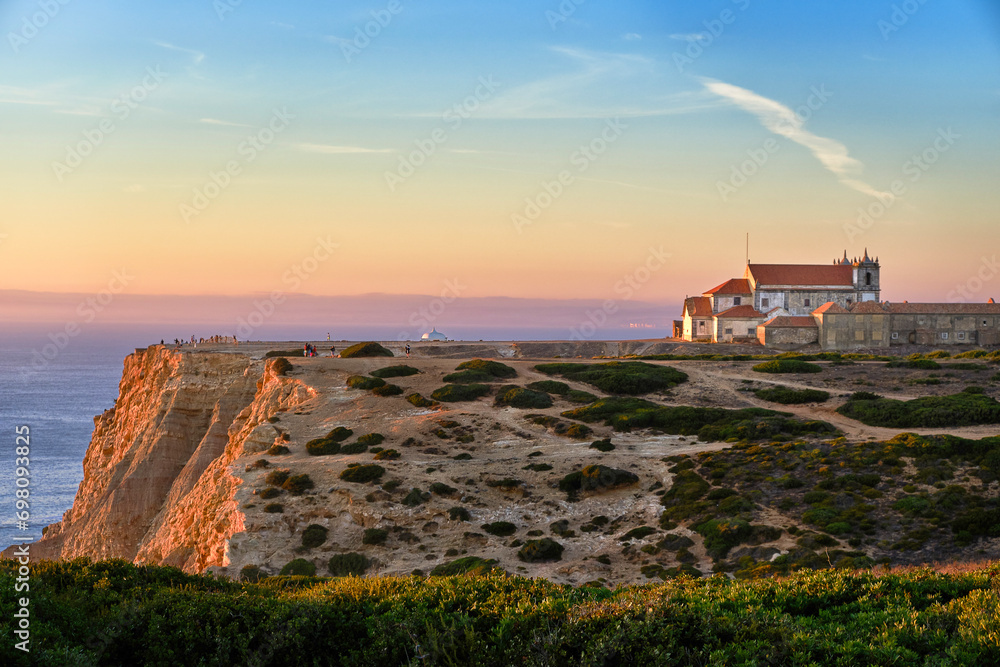 Old monastery on high cliff over seascape at sunset, Portugal