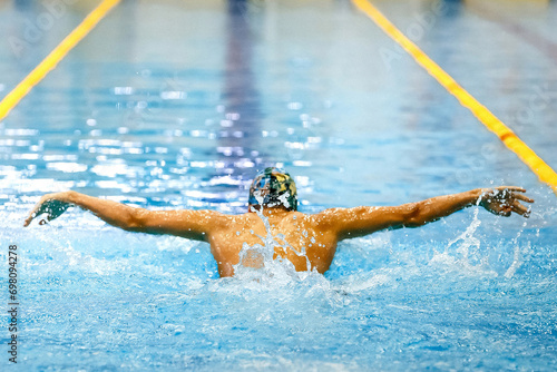 Photography rear view male athlete swim butterfly at swimming competition, summer sports gam