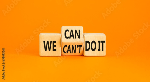 We can do it symbol. Concept word We can or can not do it on beautiful wooden cubes. Beautiful orange table orange background. Business and we can or not do it concept. Copy space.
