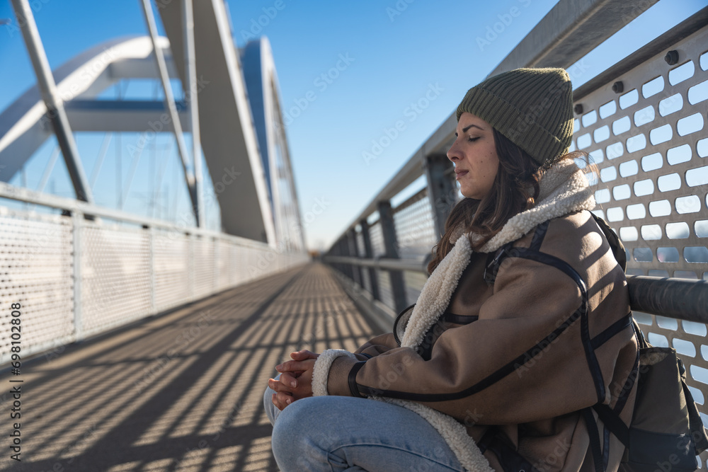 Depressed young woman and contemplating suicide, On the edge of a bridge with river below., Suicide and Major depressive disorder concept. Homeless female suffering after job loss. Homelessness issue Depressed young woman and contemplating suicide, On the edge of a bridge with river below., Suicide and Major depressive disorder concept. Homeless female suffering after job loss. Homelessness issue