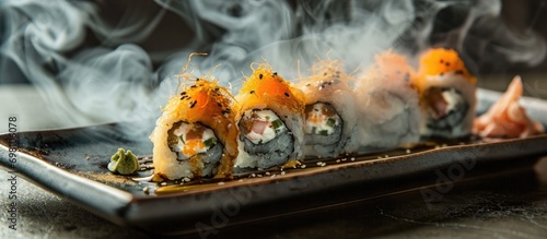 Sushi rolls on plate, with smoke around.
