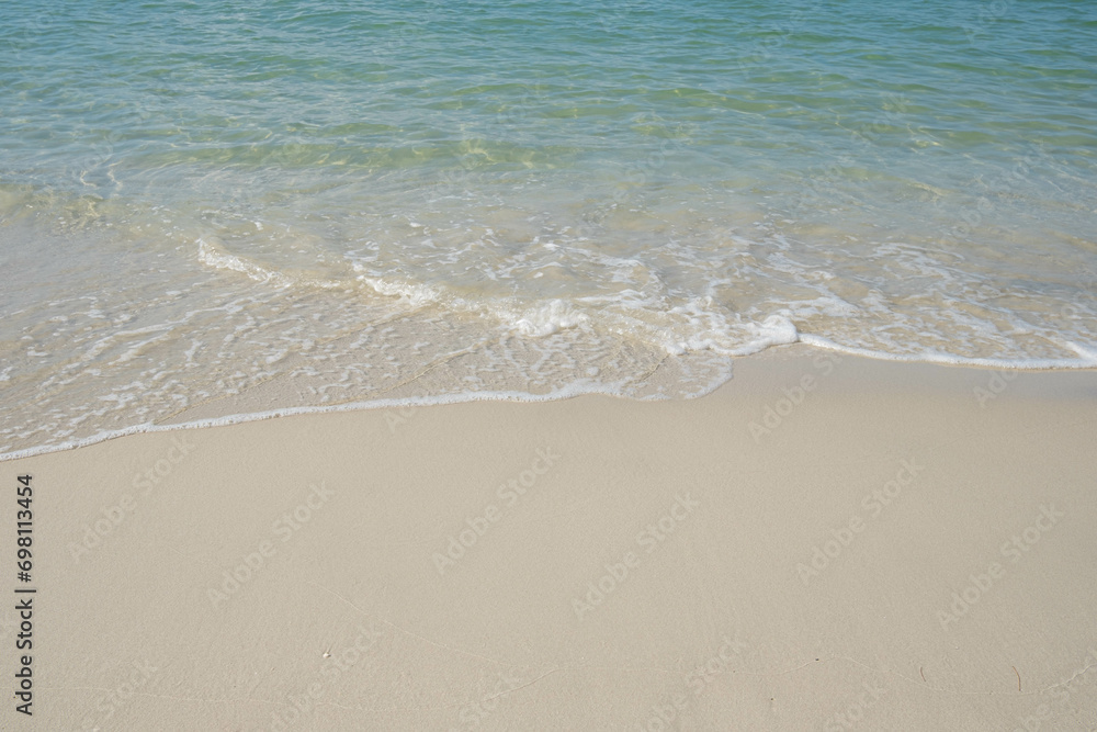 The sea is full of water lapping on the beautiful white sand beach. The sea is full of water lapping on the beautiful white sand beach.