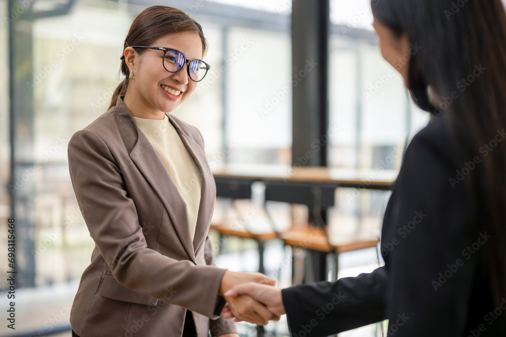 Close up of businesswoman shaking hands during a meeting success, dealing, greeting and partner concept. Close up of businesswoman shaking hands during a meeting success, dealing, greeting and partner concept.