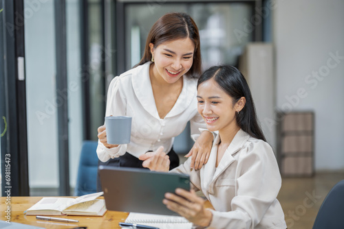 Two businessperson or colleauge use digital tablets during a coffee break. photo