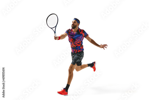 Bearded young man in colorful sportswear playing tennis, in motion with racket isolated over white background. Concept of professional sport, movement, competition, action. Ad © master1305