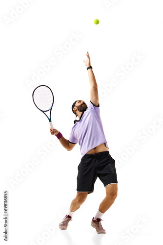 Full-length image of athletic young man, tennis player in motion with racket, practicing isolated over white background. Concept of professional sport, movement, competition, action. Ad