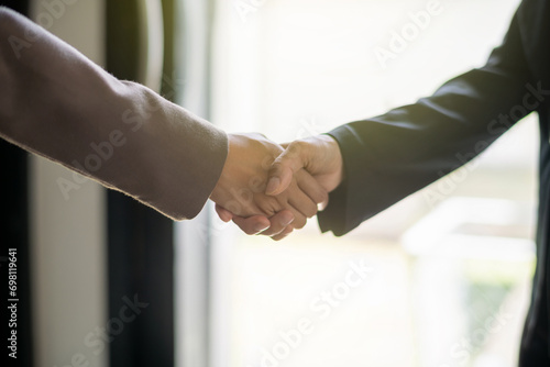 Close up hands of businessperson shaking hands during a meeting success, dealing, greeting and partner concept.