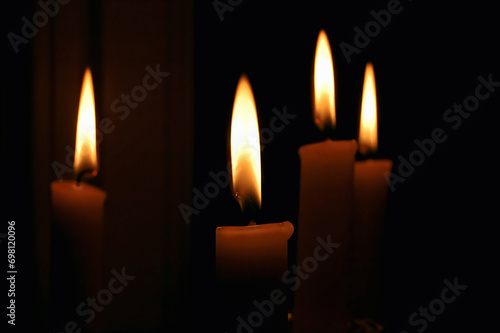 Lighting the Darkness: Four Candles Illuminating a Dark Room