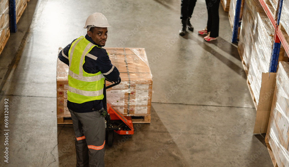 Portrait of warehouse work in a Storage worker Workers carting boxes in warehouse inventory, preparing customers' orders. Portrait of warehouse work in a Storage worker Workers carting boxes in warehouse inventory, preparing customers' orders.