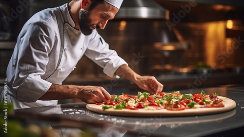 The chef of the pizzeria decorates the finished large pizza with arugula and basil leaves. Chef preparing pizza in restaurant kitchen