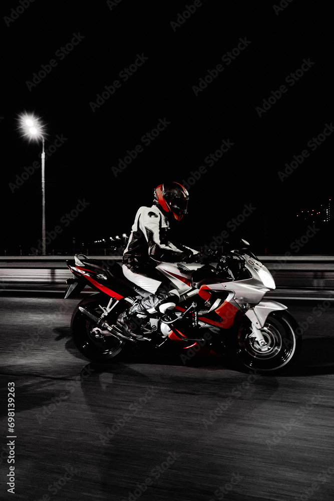 Rider on motorcycle on the road at night, closeup of photo