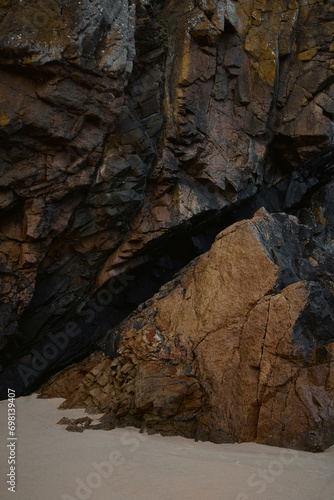 Coastal rock formation, mountain and sand