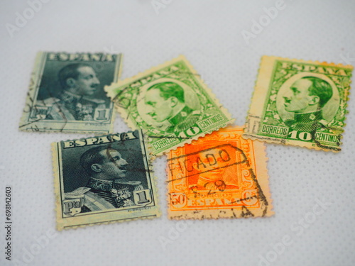 Spanish stamps from Alfonso XIII on a white background and in an album photo