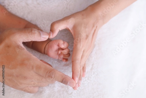 Close up parent and child hands Making a shape of heart.