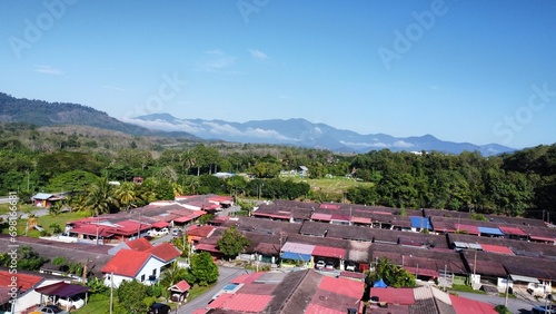 a view from drone roof top houses and himalayan mountains at kuala kangsar perak malaysia