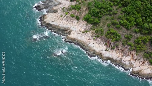 High-angle rocky beach with perfect nature Sea waves hitting the island rocks with beautiful nature