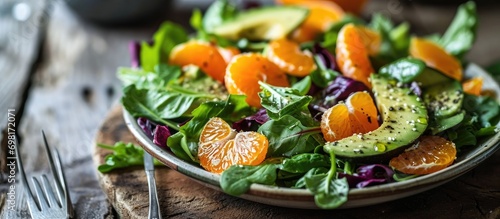 Healthy keto salad with clementines and avocado.