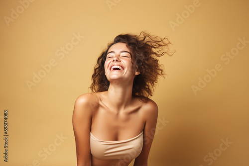 portrait of a beautiful happy smiling young woman isolated on beige background. skin care beauty, skincare cosmetics concept