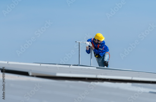 A new technician trainee working on solar panels with a fear of heights