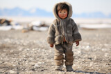Young Inuit child standing alone in Alaskan village