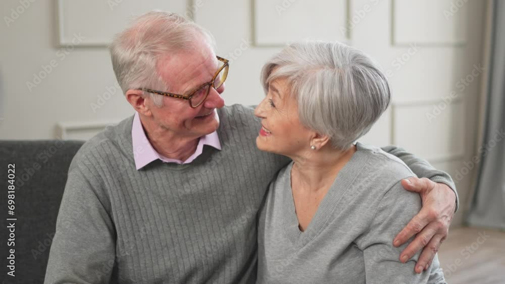 Senior adult mature couple hugging at home. Mid age old husband and wife embracing with tenderness love enjoying sweet bonding wellbeing. Grandmother grandfather together. Family moment love and care Senior adult mature couple hugging at home. Mid age old husband and wife embracing with tenderness love enjoying sweet bonding wellbeing. Grandmother grandfather together. Family moment love and care