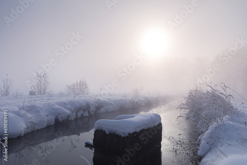 Fototapeta Naklejka Na Ścianę i Meble -  Różowy mglisty wschód słońca, zimowy krajobraz i rzeka
