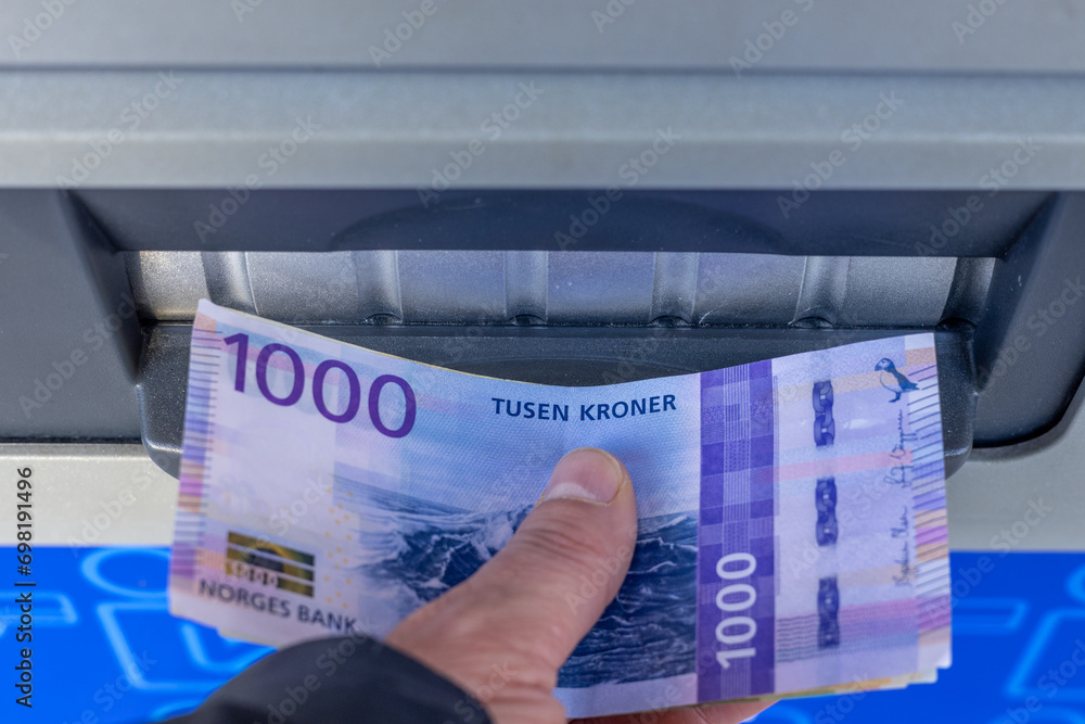 Norway money, 1000 Norwegian kroner banknote withdrawn from an ATM or inserted into a cash deposit machine, Financial concept, Home budget and cash payments - obrazy, fototapety, plakaty 