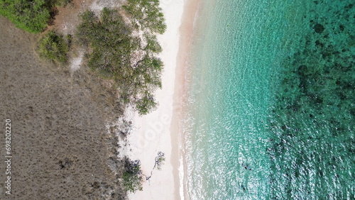 Fototapeta Naklejka Na Ścianę i Meble -  Pink Beach Komodo National Park, beautiful tropical beach in sunny day. Aerial Pink Beach, Tropical Island
