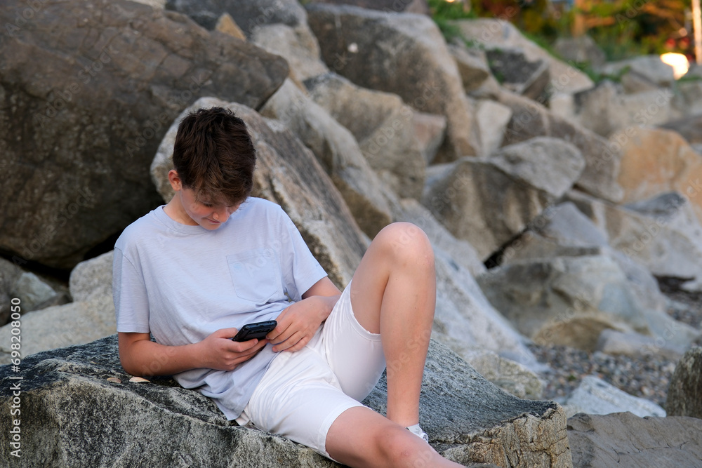 Boy with smartphone in park. High quality photo Boy with smartphone in park. High quality photo
