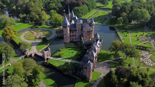 Top view of the largest castle in the Netherlands, De Haar. A beautiful quadcopter flight over the castle, the park and the water moat around the castle. A beautiful park in English style. photo