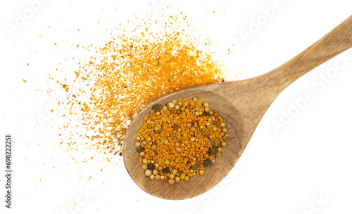 Curry spice mix in wooden spoon and minced curry, turmeric, fenugreek, mustard, coriander, paprika, pepper and cumin isolated on white