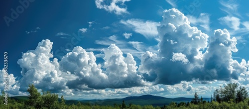 Troubling sky near Mt. Kearsarge, billowing white clouds on a summer day in Wilmot, New Hampshire. photo