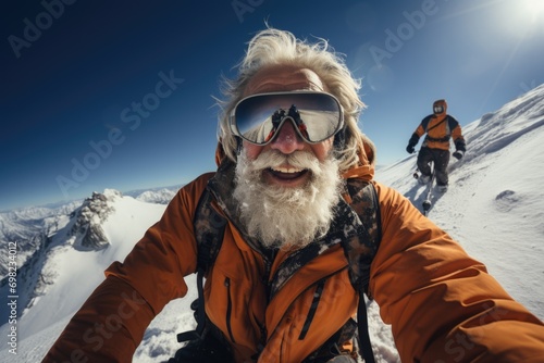 An exhilarated elderly climber takes a selfie with a companion on a snowy mountain, his reflection visible in the goggles