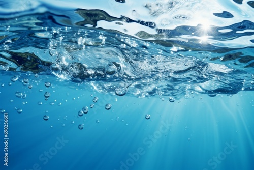 Soothing blue water background with bubbles and glistening water surface