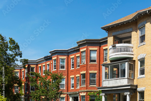 Classic style row houses in a summer day, featuring bay windows and red and yellow brick facades, Brookline, MA, USA photo