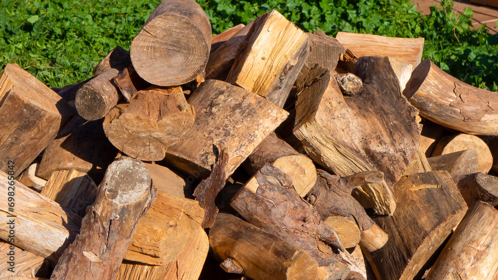 A mountain of firewood prepared for the winter for heating the house. A mountain of firewood prepared for the winter for heating the house.